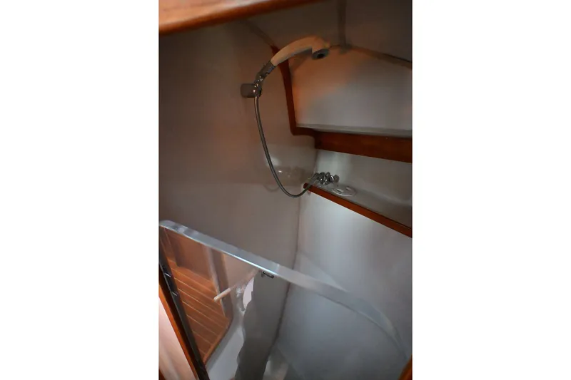 Slide: The Image of Shower area inside a 2001 Caliber 40 LRC yacht, featuring wooden accents. - 62