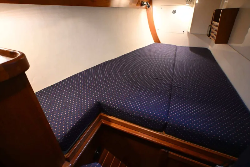 Slide: The Image of Cozy cabin berth with blue patterned cushions in 2001 Caliber 40 LRC sailboat. - 65