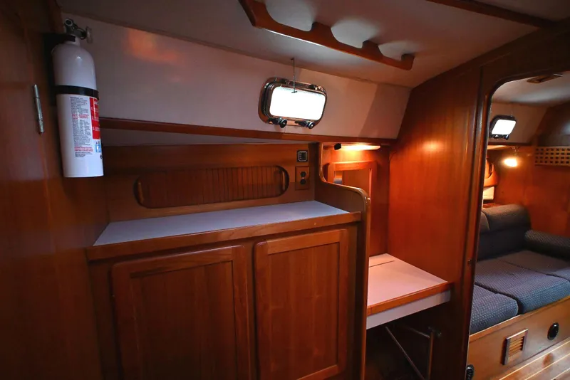 Slide: The Image of Interior of 2001 Caliber 40 LRC yacht with wooden cabinetry and seating area. - 58