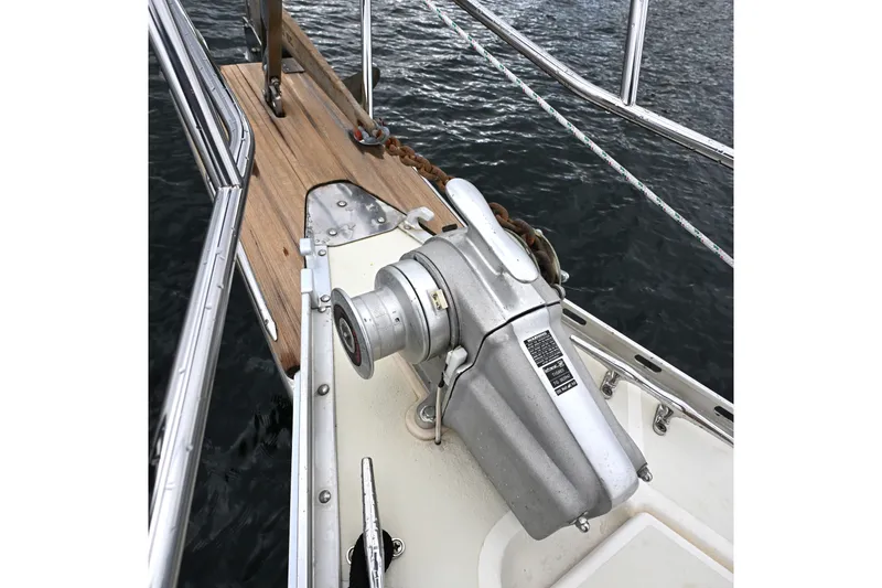 Slide: The Image of Anchor windlass on 2001 Caliber 40 LRC sailboat deck, near water. - 15