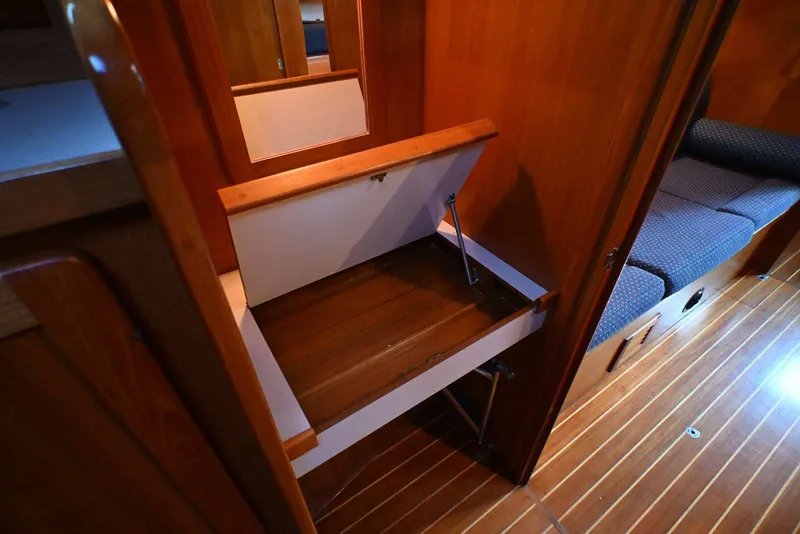 Slide: The Image of Interior of 2001 Caliber 40 LRC yacht with wooden cabinetry and fold-out storage. - 53