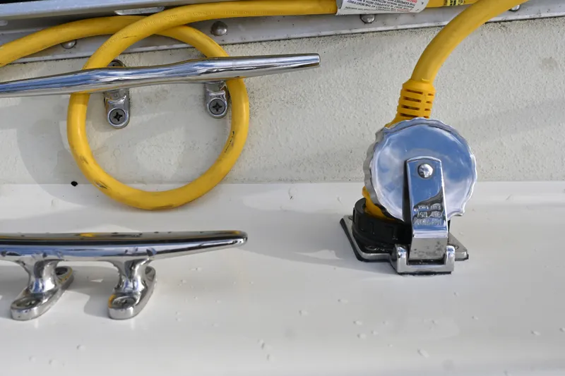 Slide: The Image of Boat deck with chrome cleats and yellow power cable, Caliber 40 LRC 2001. - 43