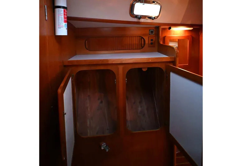 Slide: The Image of Interior of 2001 Caliber 40 LRC sailboat with wooden cabinetry and storage space. - 59