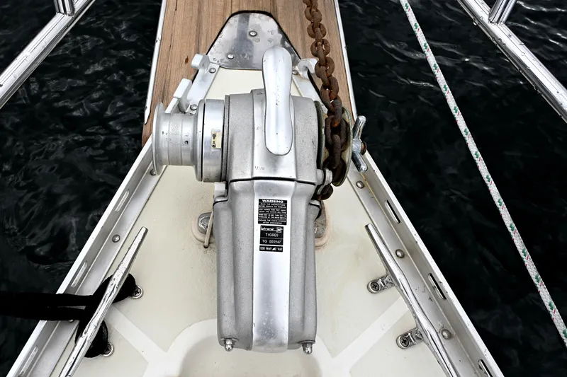 Slide: The Image of Anchor windlass on 2001 Caliber 40 LRC sailboat deck, with chain and wooden platform. - 14