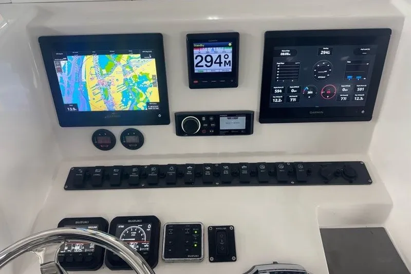 Slide: The Image of Control panel of 2020 Twin Vee 260 CC SE boat with navigation and monitoring displays. - 26