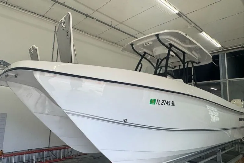 Slide: The Image of 2020 Twin Vee 260 CC SE boat in indoor storage, side view. - 15