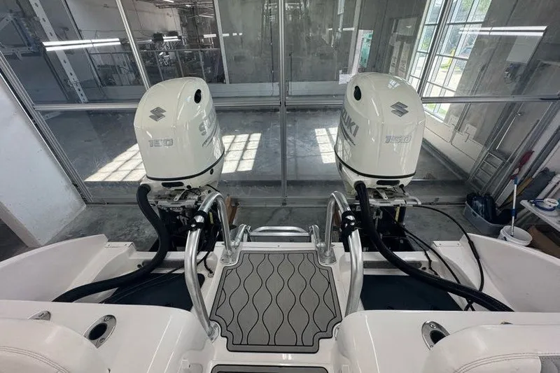Slide: The Image of Twin Vee 260 CC SE 2020 boat with dual Suzuki outboard motors in a showroom. - 41