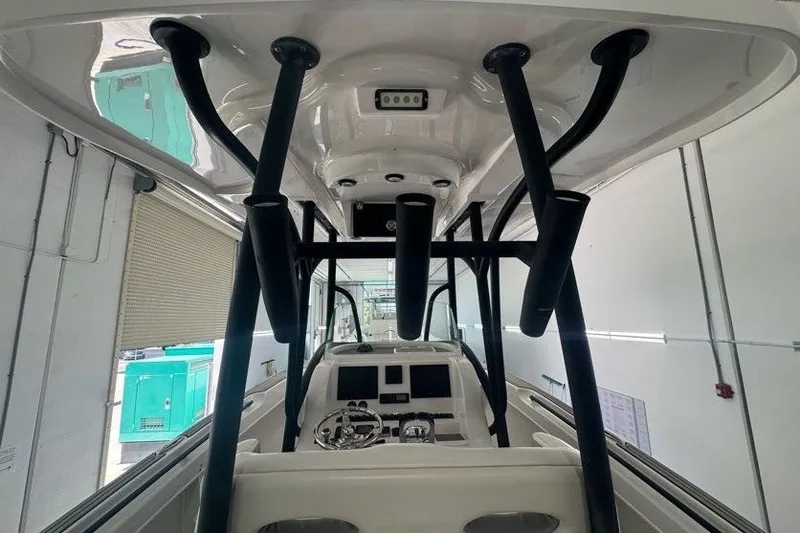 Slide: The Image of 2020 Twin Vee 260 CC SE boat interior with steering console and rod holders. - 35