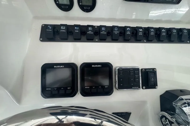 Slide: The Image of Control panel of a 2020 Twin Vee 260 CC SE boat with Suzuki displays. - 33