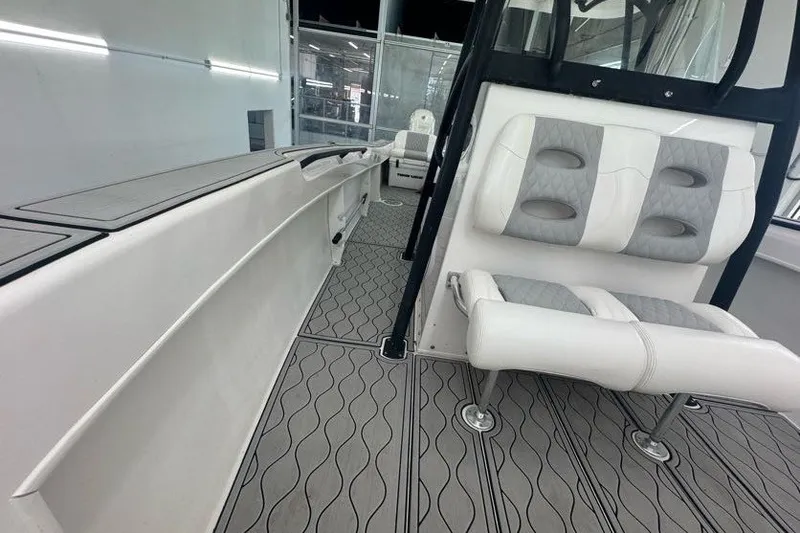 Slide: The Image of 2020 Twin Vee 260 CC SE boat interior with cushioned seating and sleek flooring. - 48