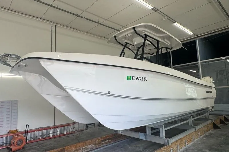 Slide: The Image of 2020 Twin Vee 260 CC SE boat in indoor storage, side view. - 13