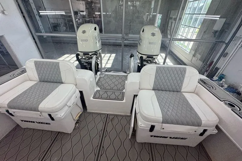 Slide: The Image of 2020 Twin Vee 260 CC SE boat interior with dual engines and cushioned seating. - 38