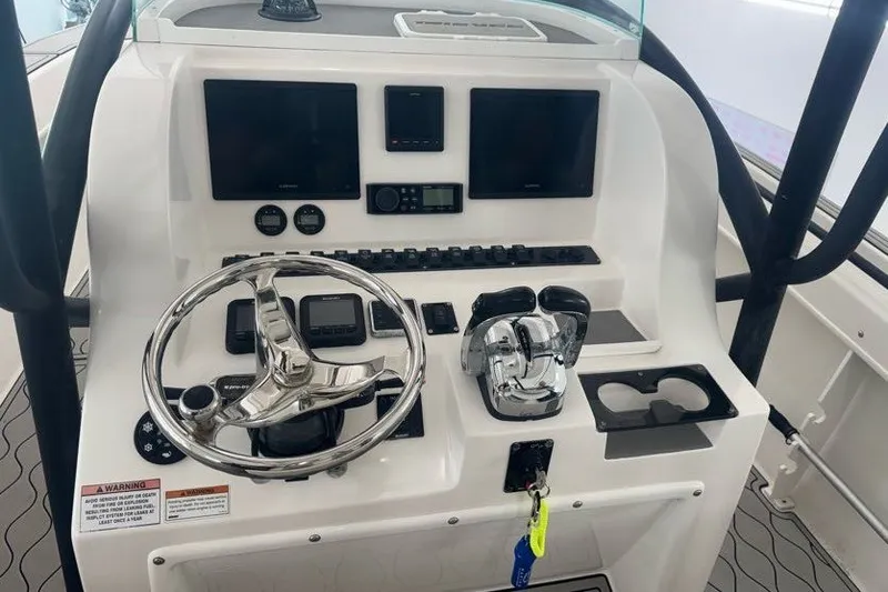 Slide: The Image of 2020 Twin Vee 260 CC SE boat console with steering wheel and controls. - 30