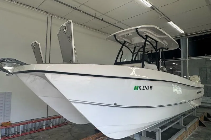 Slide: The Image of 2020 Twin Vee 260 CC SE boat in showroom, white hull, indoor display. - 16