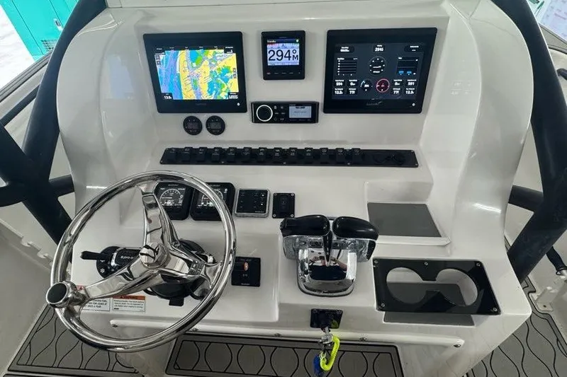 Slide: The Image of 2020 Twin Vee 260 CC SE boat dashboard with navigation screens and controls. - 25