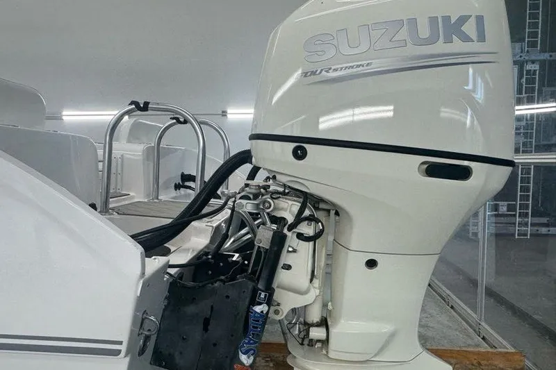 Slide: The Image of 2020 Twin Vee 260 CC SE boat with Suzuki outboard motor in a showroom. - 23