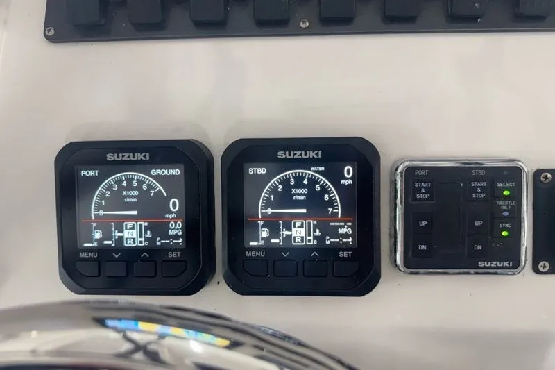 Slide: The Image of Suzuki engine controls on 2020 Twin Vee 260 CC SE boat dashboard. - 29