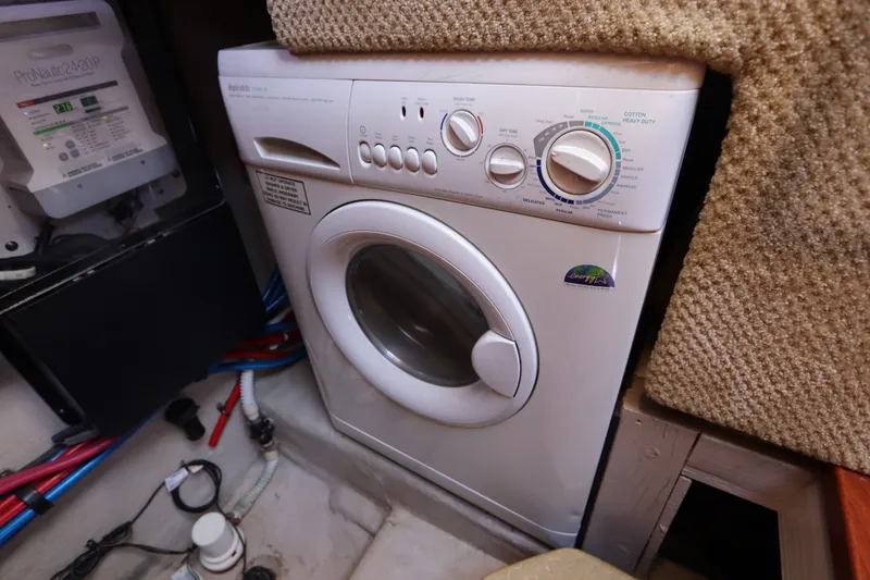 Slide: The Image of Washing machine in 2005 Sea Ray 390 Motor Yacht interior, next to electrical panel. - 58