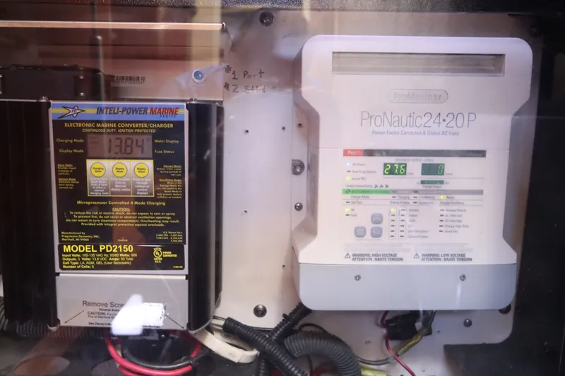 Slide: The Image of Marine battery chargers on a 2005 Sea Ray 390 Motor Yacht, featuring Intelli-Power Marine and ProNautic models. - 62
