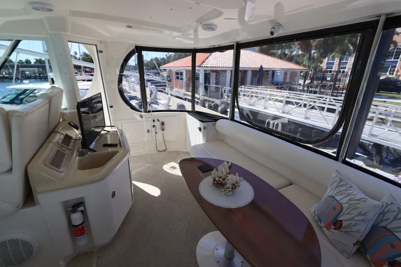 Slide: The Image of Luxurious interior of 2005 Sea Ray 390 Motor Yacht with elegant seating and panoramic windows. - 17