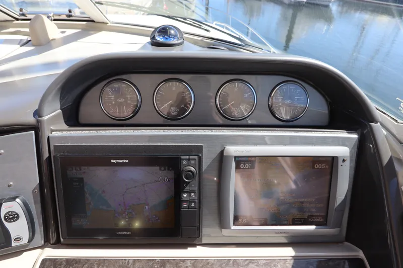 Slide: The Image of Dashboard of 2005 Sea Ray 390 Motor Yacht with navigation screens and gauges. - 27
