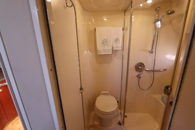 Slide: The Image of 2005 Sea Ray 390 Motor Yacht bathroom with shower, toilet, and towels. - 50
