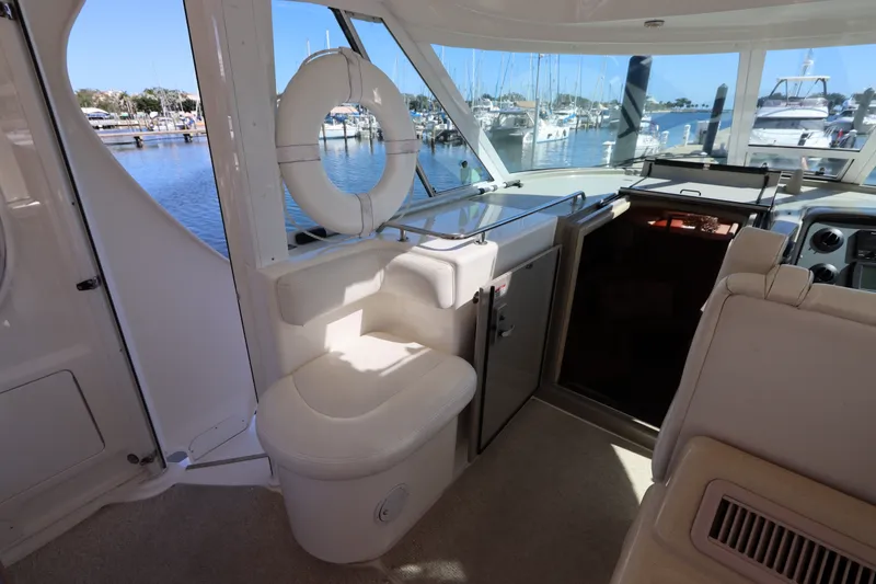 Slide: The Image of Interior view of 2005 Sea Ray 390 Motor Yacht with seating and marina backdrop. - 22
