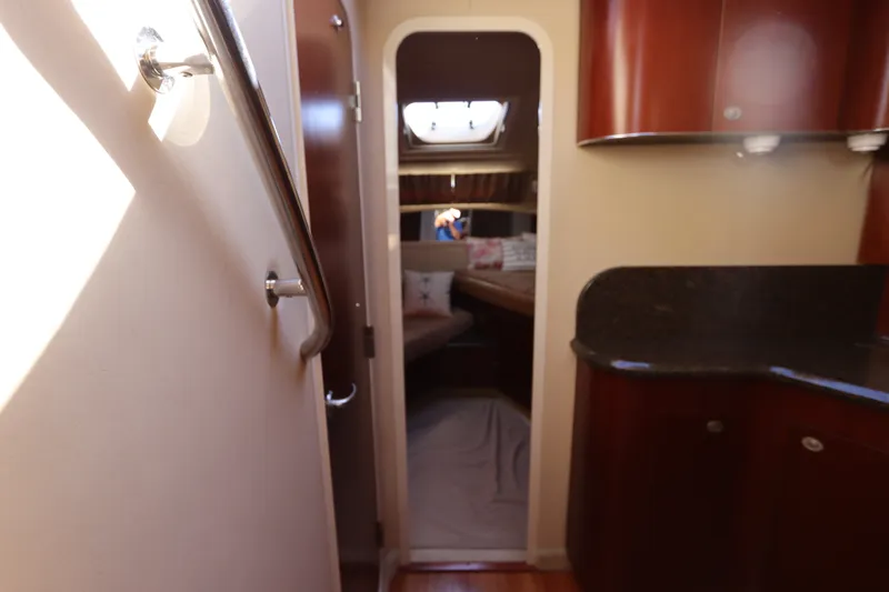 Slide: The Image of Interior view of 2005 Sea Ray 390 Motor Yacht cabin with wood finishes. - 44