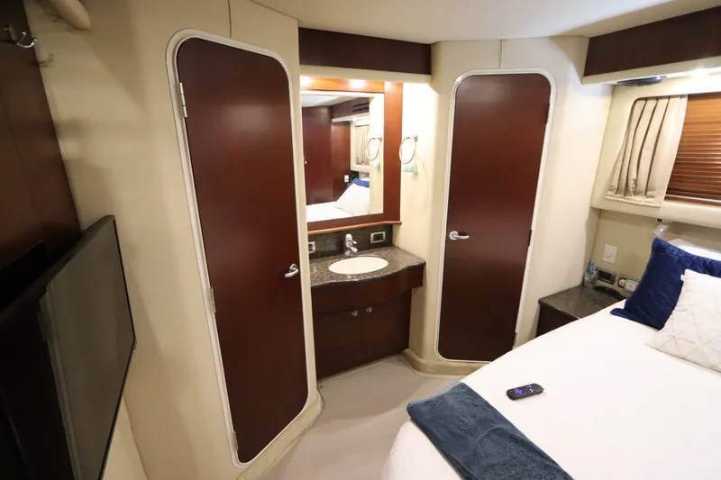 Slide: The Image of Luxurious 2005 Sea Ray 390 Motor Yacht cabin with elegant wood finishes and modern amenities. - 55