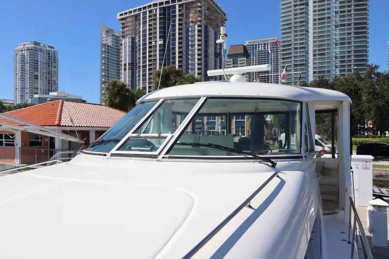Slide: The Image of 2005 Sea Ray 390 Motor Yacht docked in urban marina with skyscrapers in background. - 14