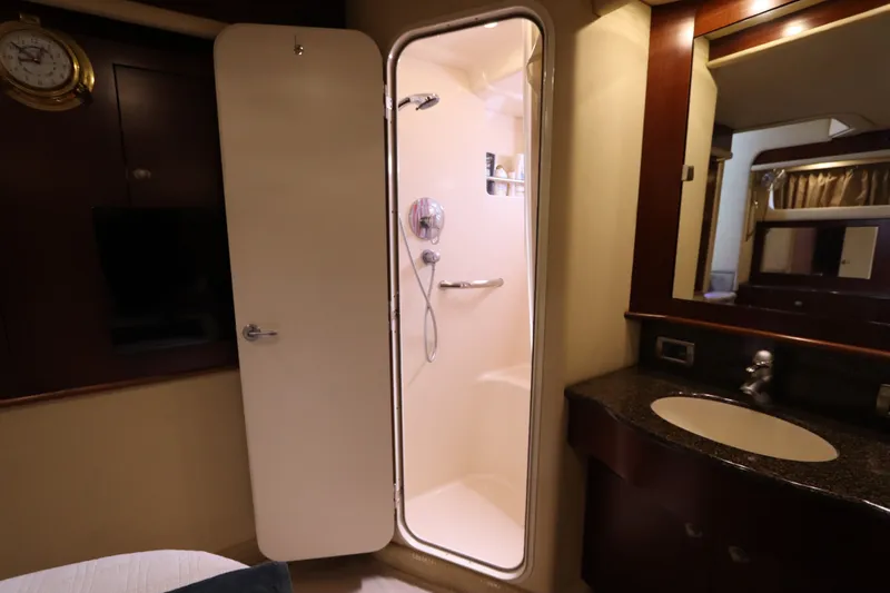 Slide: The Image of 2005 Sea Ray 390 Motor Yacht bathroom with shower and sink area. - 56
