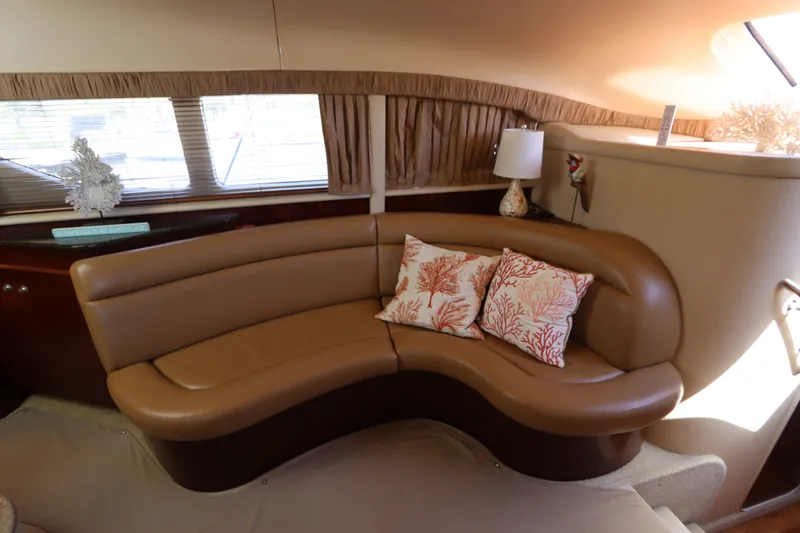 Slide: The Image of Luxurious interior of 2005 Sea Ray 390 Motor Yacht with curved leather seating and decorative pillows. - 32