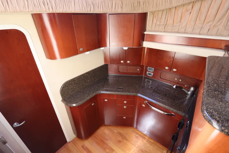 Slide: The Image of Luxurious 2005 Sea Ray 390 Motor Yacht kitchen with sleek wood cabinetry and granite countertops. - 37