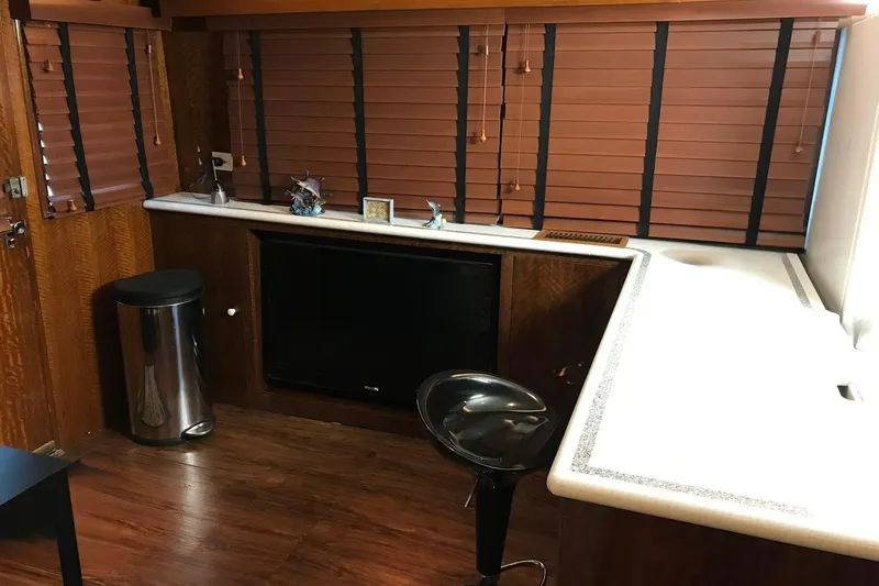 Slide: The Image of Interior of a 1976 Hatteras 53 Convertible with wood paneling and modern amenities. - 17
