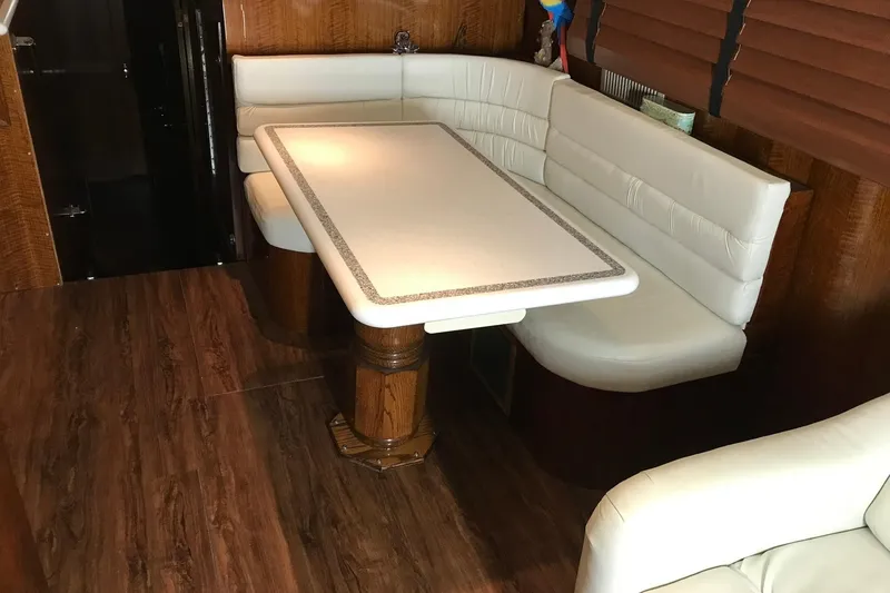 Slide: The Image of Interior of a 1976 Hatteras 53 Convertible with an elegant seating area and wooden flooring. - 16