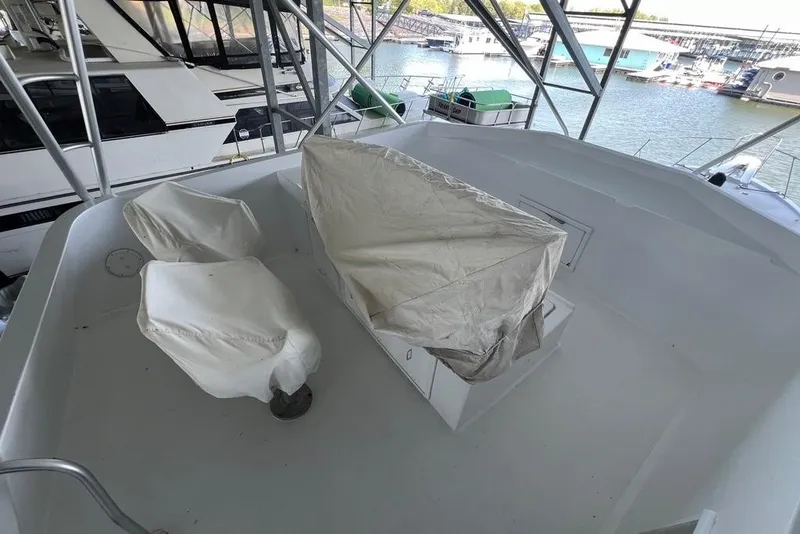 Slide: The Image of The image shows the deck of a 1976 Hatteras 53 Convertible with covered seats. - 4