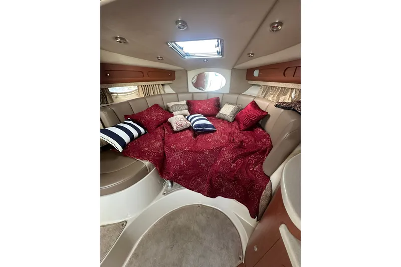 Slide: The Image of Interior of 2002 Chaparral Signature 320 boat with cozy bed and decorative pillows. - 25