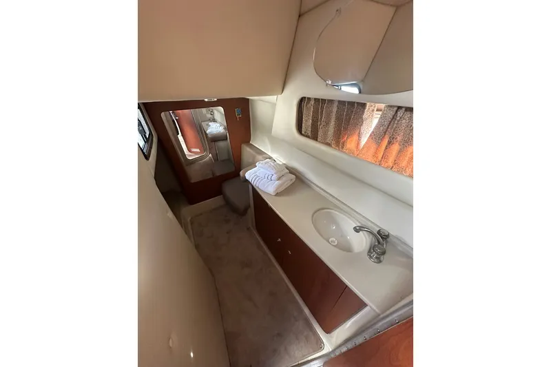 Slide: The Image of 2002 Chaparral Signature 320 bathroom interior with sink, mirror, and towels. - 23