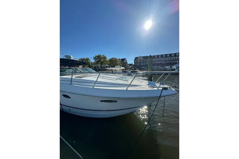 Slide: The Image of 2002 Chaparral Signature 320 boat docked under a bright sunlit sky. - 3