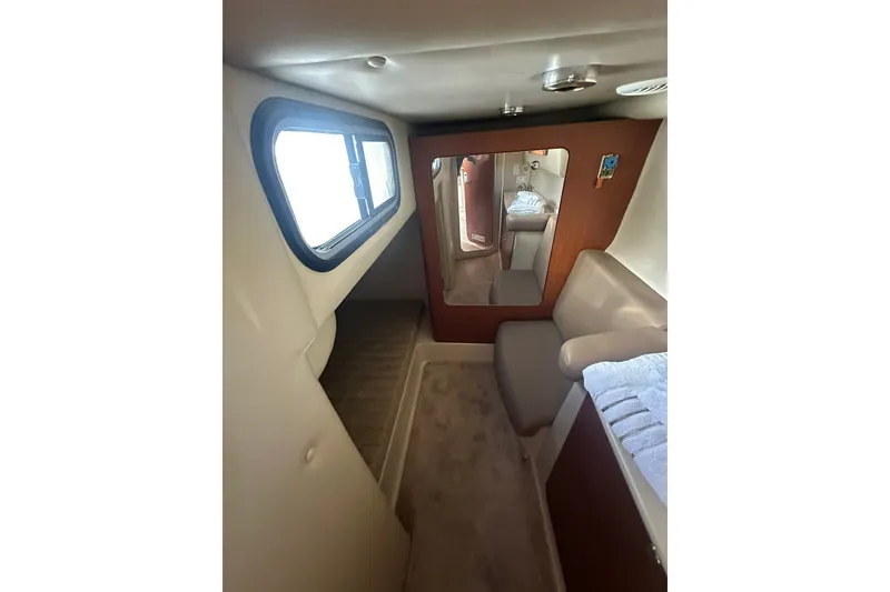 Slide: The Image of Interior of 2002 Chaparral Signature 320 boat, featuring a cozy cabin space. - 24