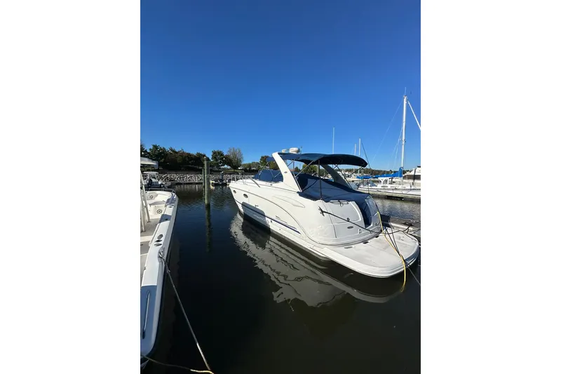 Slide: The Image of Chaparral Signature 320 boat, 2002 model, docked in a marina under clear blue sky. - 6