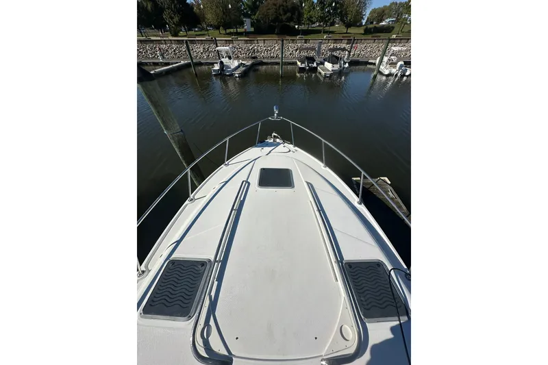 Slide: The Image of 2002 Chaparral Signature 320 boat docked at marina, view from bow. - 4