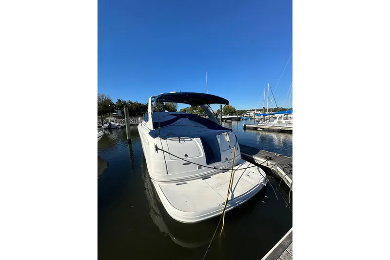 Slide: The Image of 2002 Chaparral Signature 320 boat docked at marina under clear blue sky. - 5