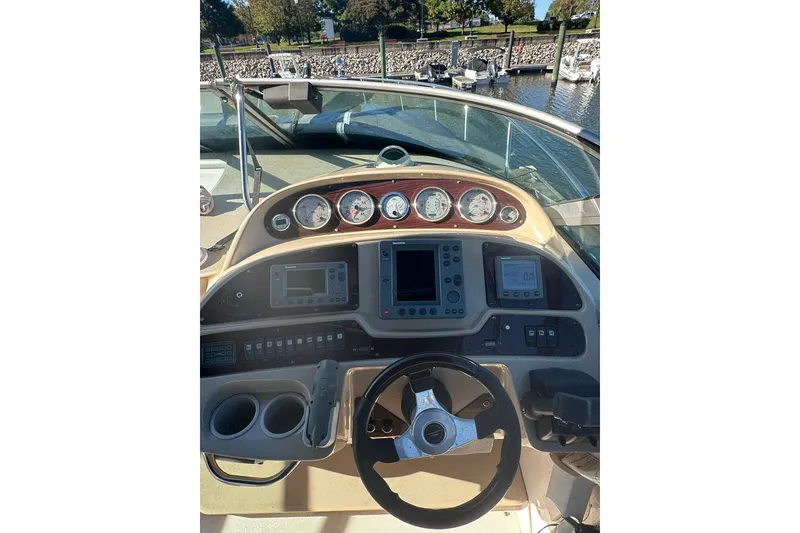 Slide: The Image of Cockpit of 2002 Chaparral Signature 320 boat with steering wheel and navigation instruments. - 12