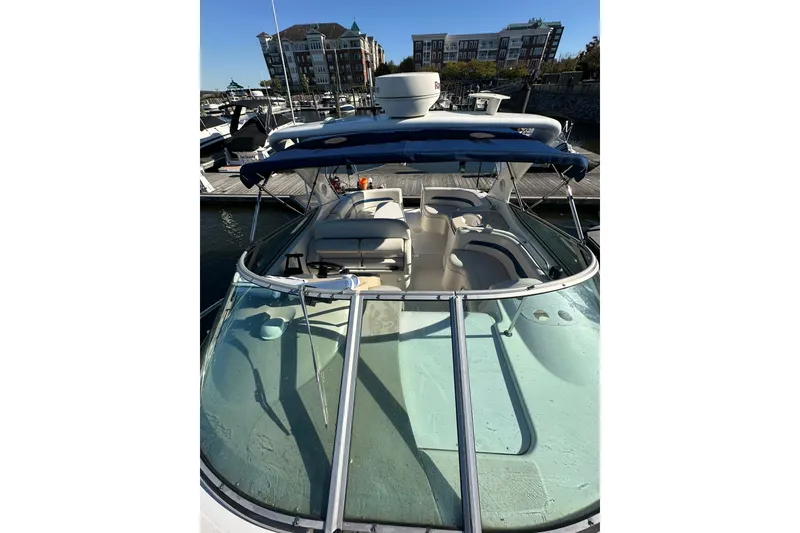 Slide: The Image of 2002 Chaparral Signature 320 boat docked at marina, featuring spacious seating and blue canopy. - 14