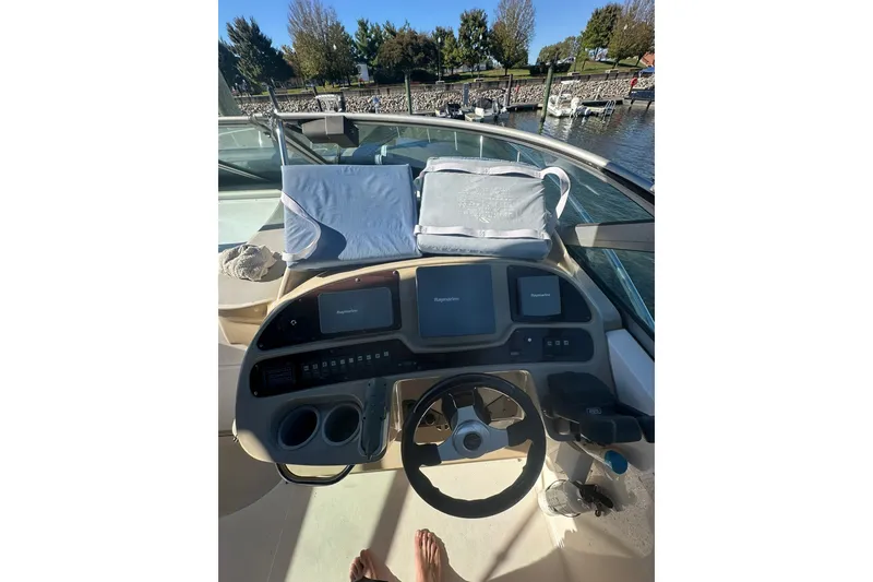 Slide: The Image of Cockpit view of 2002 Chaparral Signature 320 boat with steering wheel and navigation screens. - 9