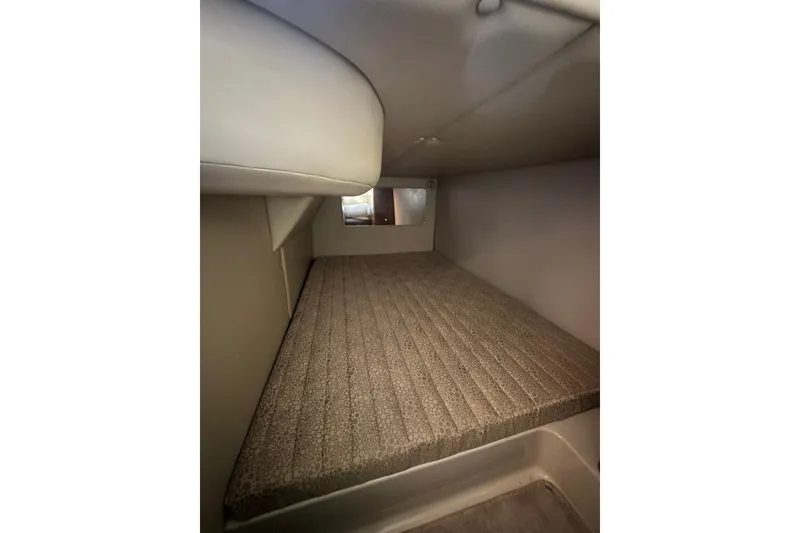 Slide: The Image of 2002 Chaparral Signature 320 cabin interior with cushioned sleeping area. - 22