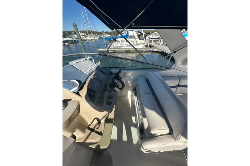 Slide: The Image of 2002 Chaparral Signature 320 boat interior with helm and seating, docked at marina. - 10