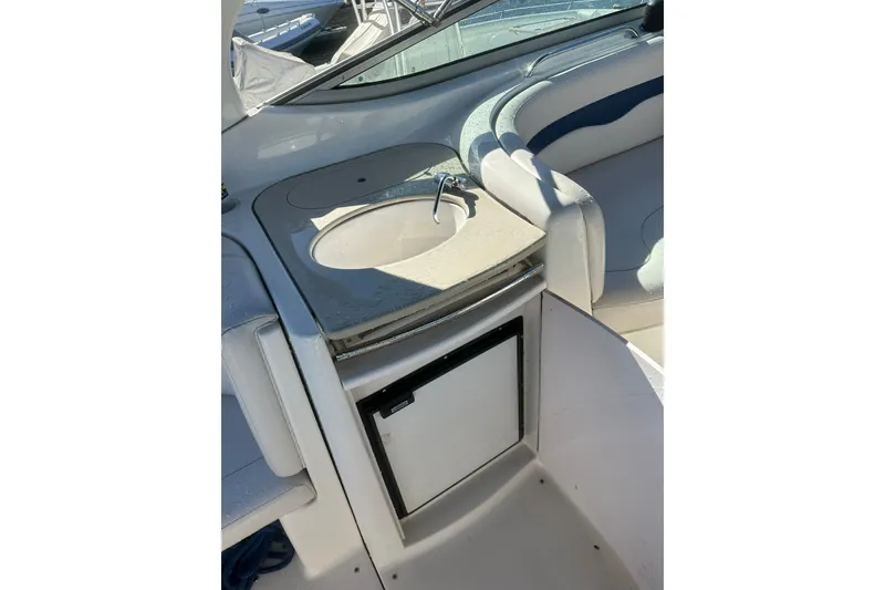 Slide: The Image of 2002 Chaparral Signature 320 boat interior with sink and mini fridge. - 11