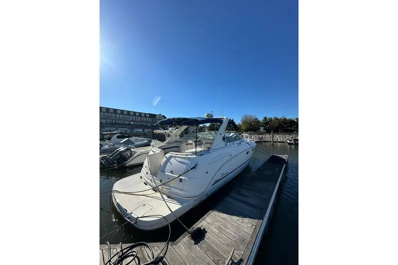 Slide: The Image of 2002 Chaparral Signature 320 boat docked at marina under clear blue sky. - 1